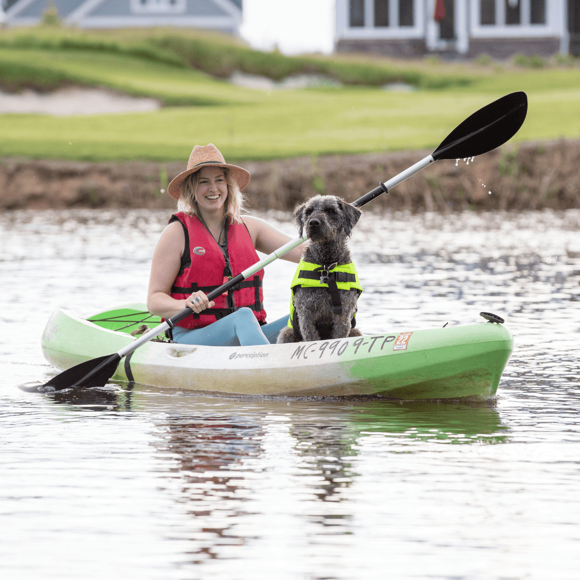 women kayaking with dog