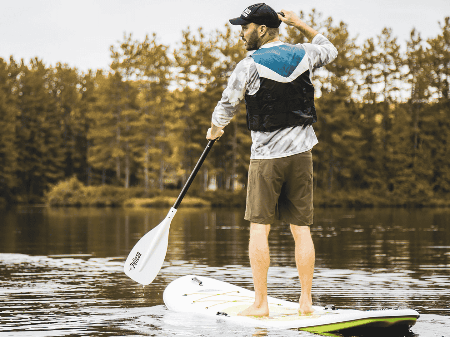 man stand up paddleboarding near Douglas