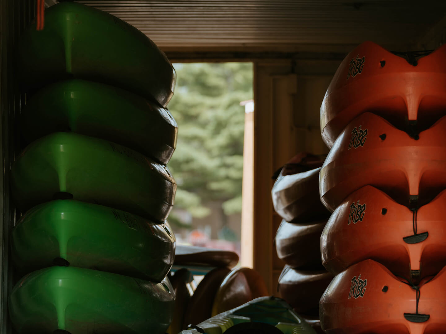 kayaks and paddleboards stacked