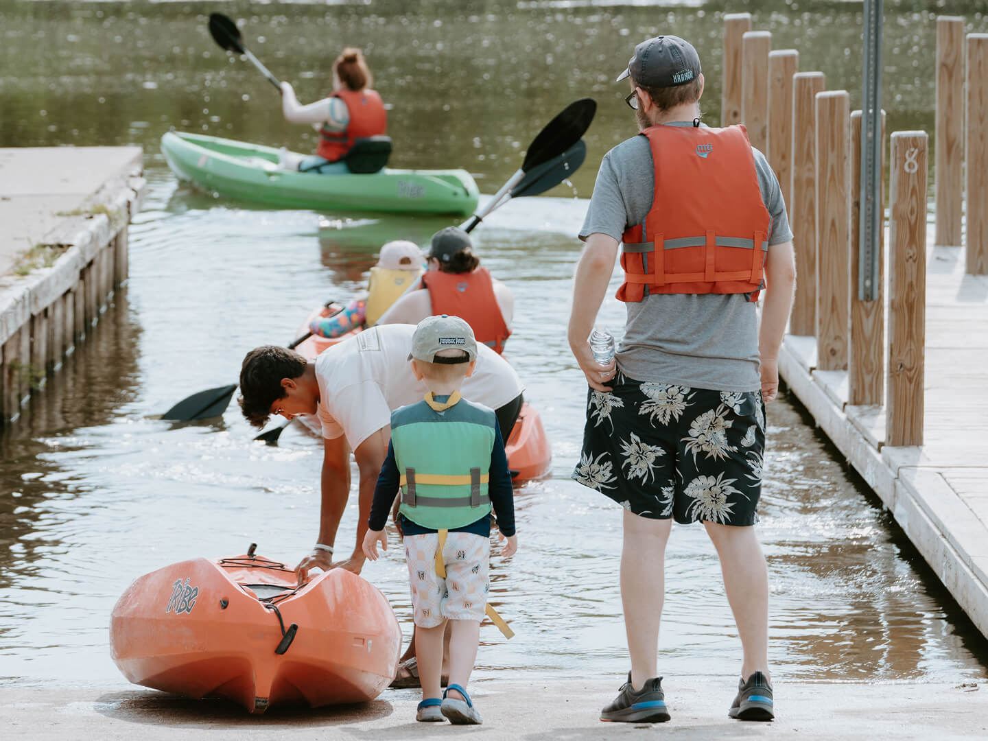 father and son pulling kayak towards the galien river