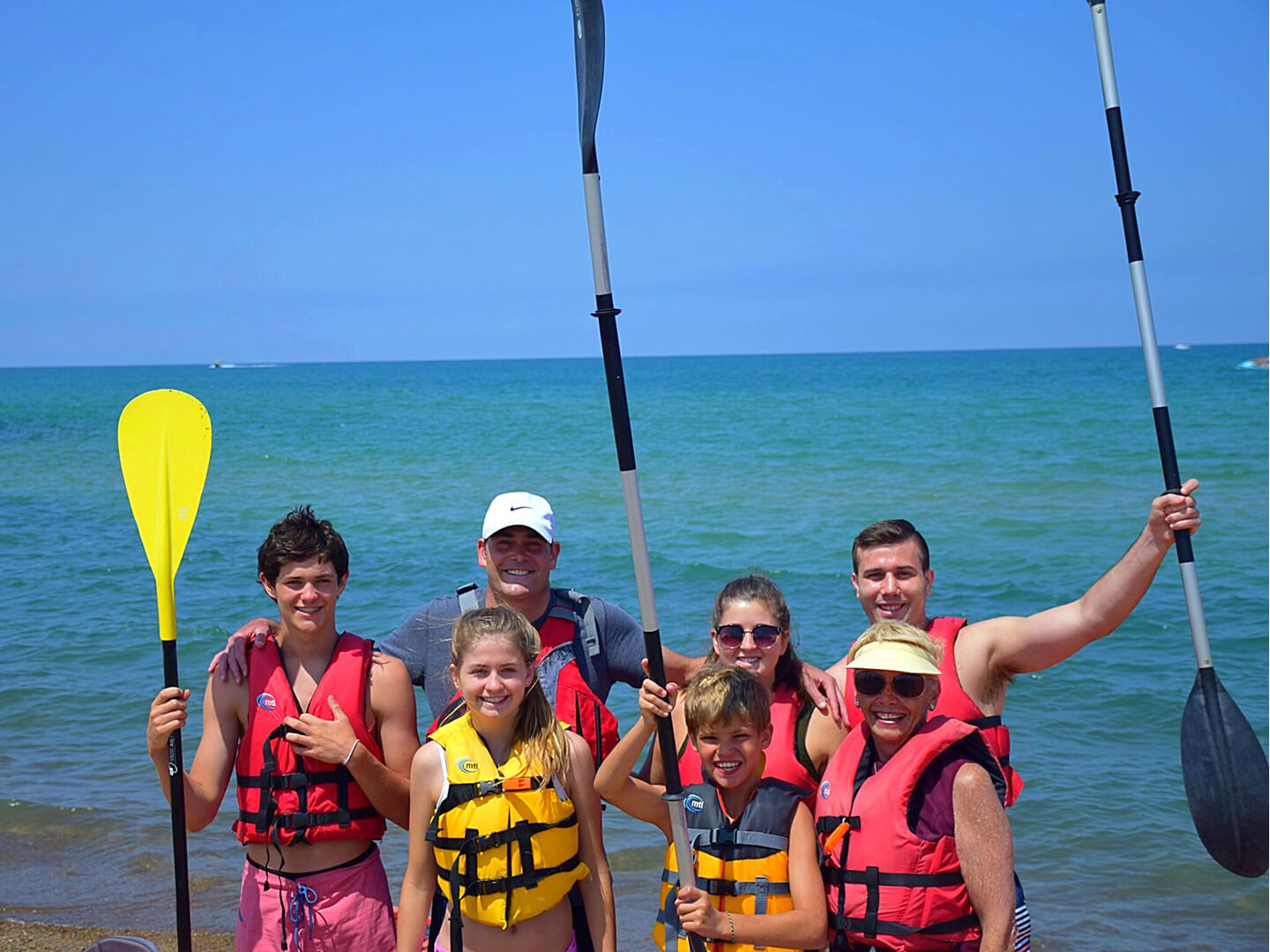 family standing at the beach