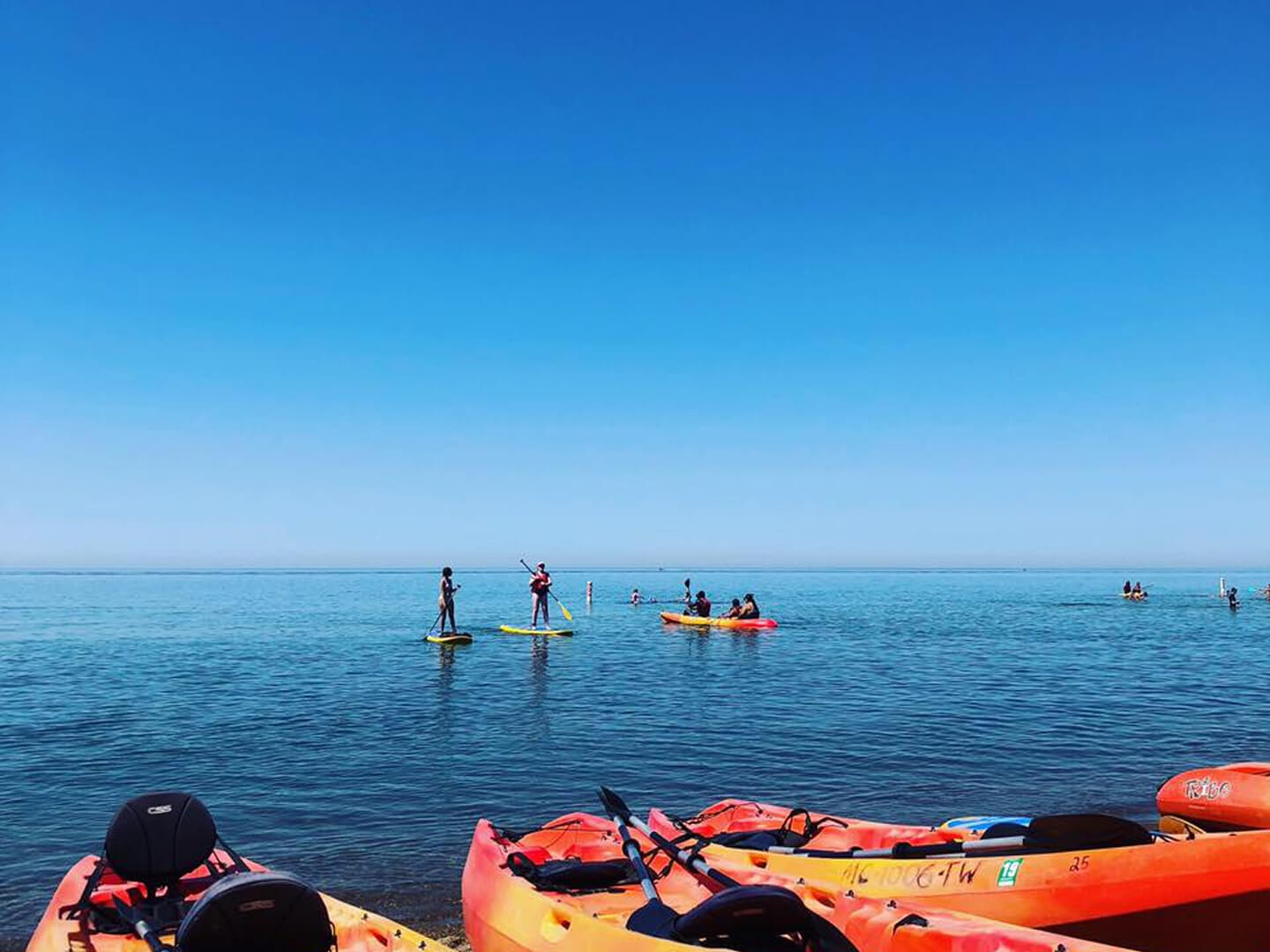 kayaks floating in the water at jean klock beach