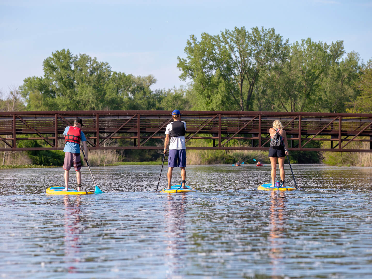 three people paddleboarding
