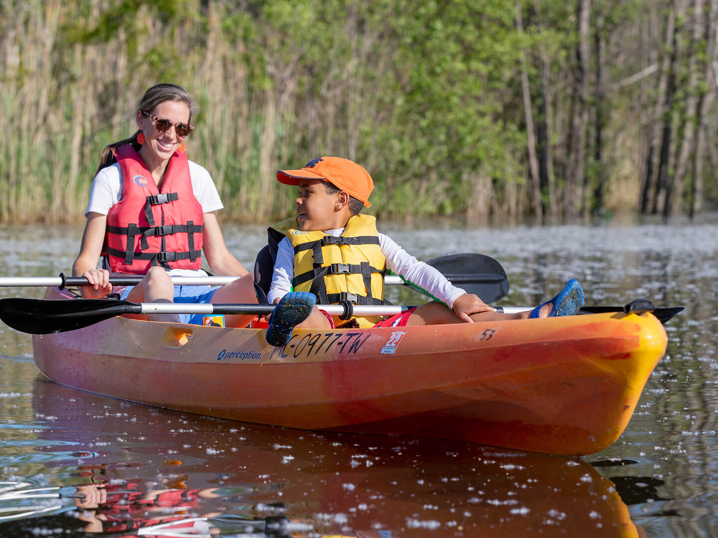mom and son paddleboarding on the paw paw river