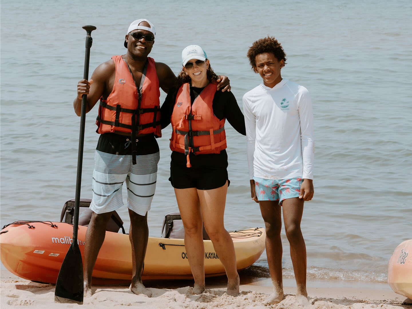 family of three kayaking at silver beach MI