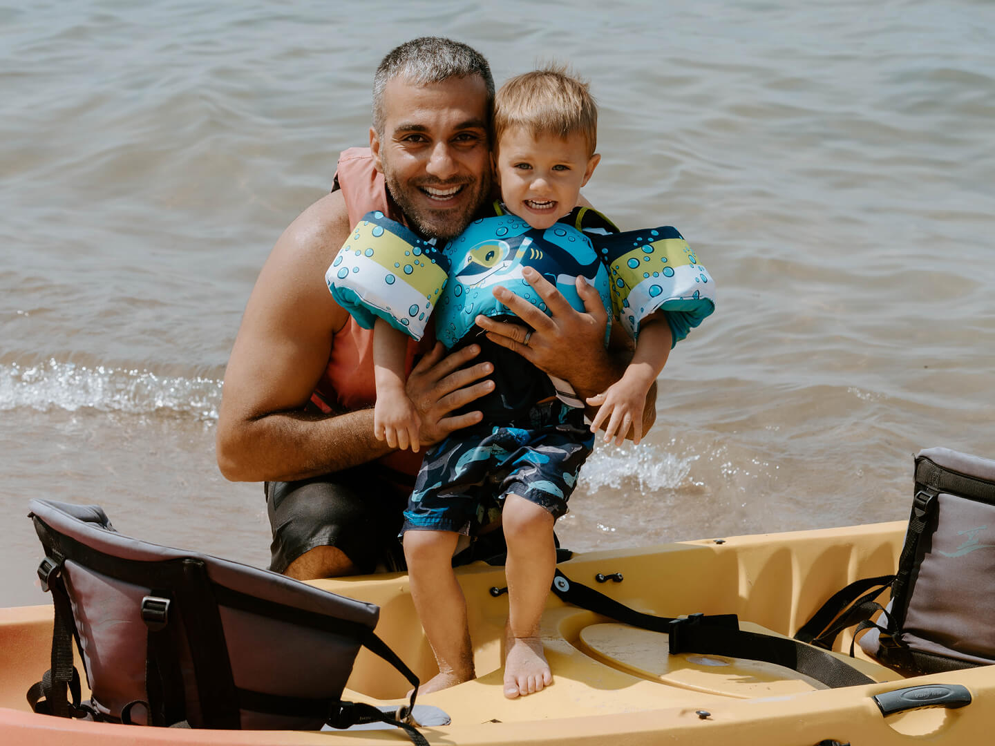 father and son kayaking at silver beach