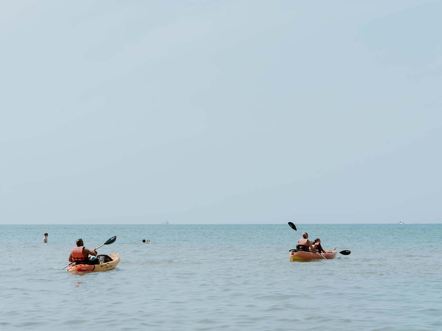 two group kayaking at the beach
